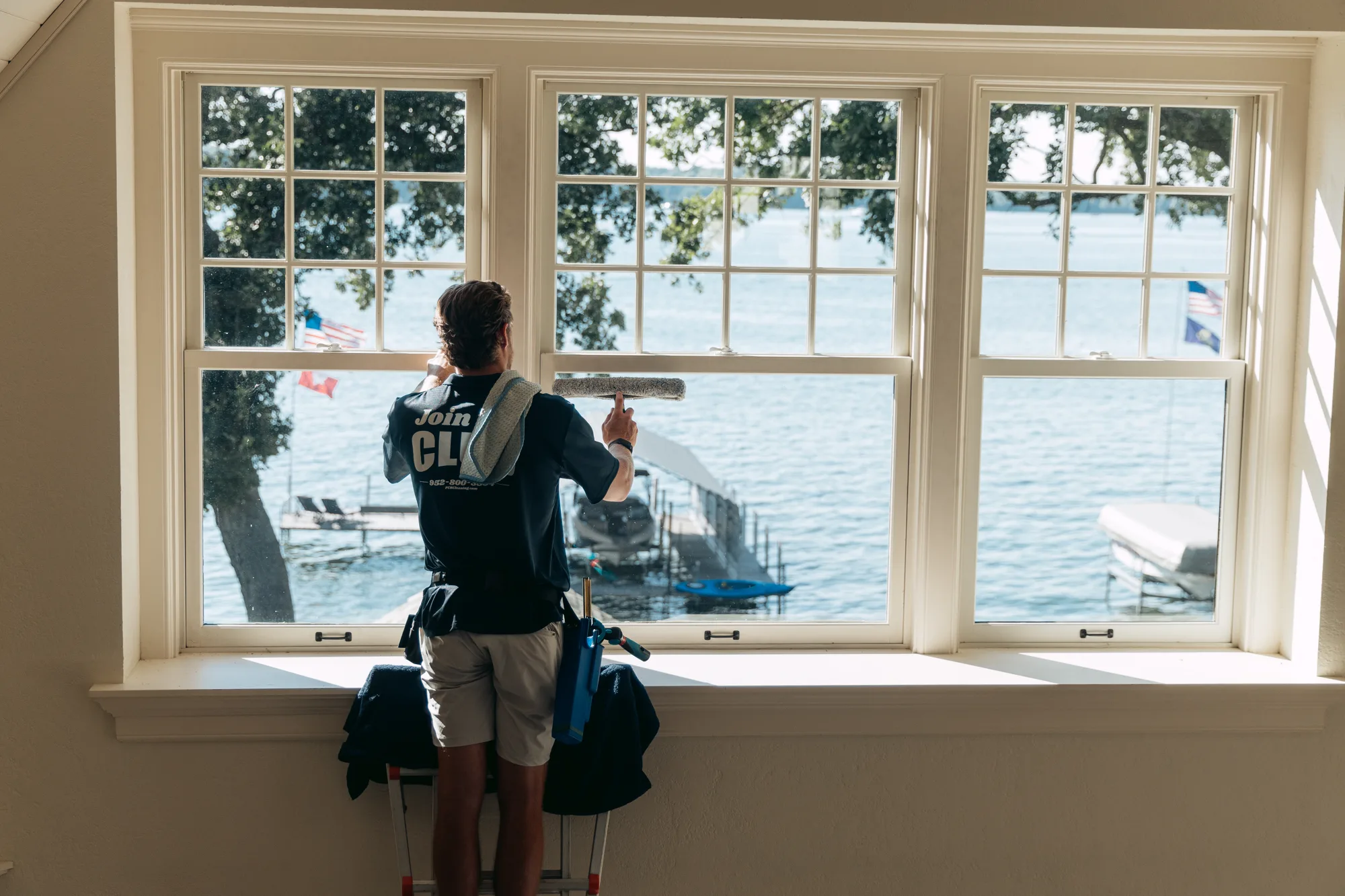 FCR technician finishing a wide lake-view bay window — window cleaning Twin Cities MN